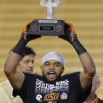 Oklahoma State linebacker Seth Jacobs holds the defensive player of the game award after the Cactus Bowl NCAA college football game against Washington, Friday, Jan. 2, 2015, in Tempe, Ariz. Oklahoma State won 30-22. (AP Photo/Rick Scuteri)