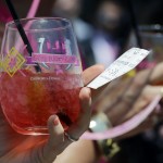 A fan holds a drink before the 141st running of the Kentucky Oaks horse race at Churchill Downs Friday, May 1, 2015, in Louisville, Ky. (AP Photo/Darron Cummings)