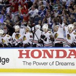 Members of the Chicago Blackhawks celebrate after Brent Seabrook's goal during the third period in Game 2 of the NHL hockey Stanley Cup Final against the Tampa Bay Lightning in Tampa, Fla., Saturday, June 6, 2015. (AP Photo/Chris O'Meara)