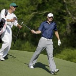 Jordan Spieth gets his putter from caddie Michael Greller after teeing off on the 12th fairway during the third round of the Masters golf tournament Saturday, April 12, 2014, in Augusta, Ga. (AP Photo/Darron Cummings)