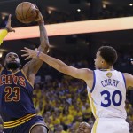 Cleveland Cavaliers forward LeBron James (23) shoots against Golden State Warriors guard Stephen Curry (30) during the first half of Game 5 of basketball's NBA Finals in Oakland, Calif., Sunday, June 14, 2015. (AP Photo/Ben Margot)
