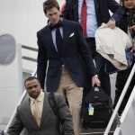 New England Patriots quarterback Tom Brady, center, arrives with his teammates at Sky Harbor Airport for NFL Super Bowl XLIX football game against the Seattle Seahawks Monday, Jan. 26, 2015, in Phoenix. (AP Photo/David J. Phillip)
