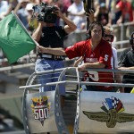 Dallas Mavericks owner Mark Cuban waves the green flag to start the 98th running of the Indianapolis 500 IndyCar auto race at the Indianapolis Motor Speedway in Indianapolis, Sunday, May 25, 2014. (AP Photo/Michael Conroy)