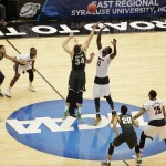 Michigan State's Gavin Schilling (34) and Louisville's Mangok Mathiang (12), of Australia, fight for the tipoff during the first half of a regional final in the NCAA men's college basketball tournament Sunday, March 29, 2015, in Syracuse, N.Y. (AP Photo/Frank Franklin II)