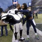 Seattle Seahawks' Richard Sherman, right, trades jerseys with Oakland Raiders' Charles Woodson after an NFL football game, Sunday, Nov. 2, 2014, in Seattle. The Seahawks won 30-24. (AP Photo/Elaine Thompson)