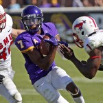 East Carolina's Isaiah Jones (7) prepares for a shot from Southern Methodist's Jonathan Yenga (1) with John Bordano (46) giving chase during the second half of an NCAA college football game in Greenville, N.C., Saturday, Oct. 4, 2014. ECU won 45-24. (AP Photo/Karl B DeBlaker)