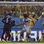 Germany's Mats Hummels, center, score the opening goal during the World Cup quarterfinal soccer match between Germany and France at the Maracana Stadium in Rio de Janeiro, Brazil, Friday, July 4, 2014. (AP Photo/Martin Meissner)