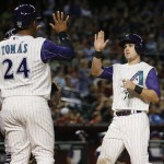 Arizona Diamondbacks' Chris Owings, right, and Yasmany Tomas celebrate after scoring on an double by Tuffy Gosewisch during the fifth inning of a baseball game against the San Diego Padres, Thursday, May 7, 2015, in Phoenix. (AP Photo/Matt York)