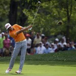 Rickie Fowler hits from the fairway on the first hole during the final round of the PGA Championship golf tournament at Valhalla Golf Club on Sunday, Aug. 10, 2014, in Louisville, Ky. (AP Photo/John Locher)
