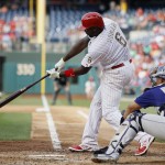  Philadelphia Phillies' Ryan Howard, left, hits an RBI-single off Colorado Rockies starting pitcher Jhoulys Chacin during the fourth inning of a baseball game, Monday, May 26, 2014, in Philadelphia. At right, is catcher Wilin Rosario. (AP Photo/Matt Slocum)