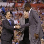 Naismith Memorial Basketball Hall of Fame class of 2015 members, from left, Kentucky coach John Calipari, former ABA player Louie Dampier and former NBA player Dikembe Mutumbo react as they are introduced during the NCAA Final Four college basketball tournament championship game between Wisconsin and Duke Monday, April 6, 2015, in Indianapolis. (AP Photo/Michael Conroy)