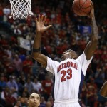 Arizona's Rondae Hollis-Jefferson dunks over Oregon's Dillon Brooks during the second half of an NCAA college basketball game in the championship of the Pac-12 conference tournament Saturday, March 14, 2015, in Las Vegas. Arizona won 80-52. (AP Photo/John Locher)
