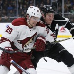 Arizona Coyotes left wing Tye McGinn, left, and Los Angeles Kings defenseman Matt Greene, right, fight for position during the first period of an NHL hockey game, Monday, March 16, 2015, in Los Angeles. (AP Photo/Danny Moloshok)