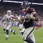 Houston Texans' J.J. Watt (99) is chased by Indianapolis Colts' Andrew Luck (12) as he returns a fumble for a 45-yard touchdown during the second half of an NFL football game, Thursday, Oct. 9, 2014, in Houston. (AP Photo/Patric Schneider)