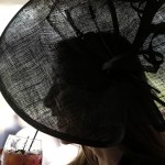 Erin Kay has a drink before the 141th running of the Kentucky Oaks horse race at Churchill Downs Friday, May 1, 2015, in Louisville, Ky. (AP Photo/Charlie Riedel)