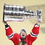 Chicago Blackhawks' Kimmo Timonen, of Finland, hoists the Stanley Cup trophy after defeating the Tampa Bay Lightning in Game 6 of the NHL hockey Stanley Cup Final series on Wednesday, June 10, 2015, in Chicago. The Blackhawks defeated the Lightning 2-0 to win the series 4-2. (AP Photo/Charles Rex Arbogast)
