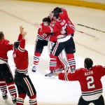 Members of the Chicago Blackhawks' celebrate after defeating the Tampa Bay Lightning in Game 6 of the NHL hockey Stanley Cup Final series on Monday, June 15, 2015, in Chicago. The Blackhawks defeated the Lightning 2-0 to win the series 4-2. (AP Photo/Charles Rex Arbogast)