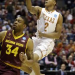  Texas's Demarcus Holland (2) drives to the basket against Arizona State's Jermaine Marshall (34) during the first half of a second-round game in the NCAA college basketball tournament Thursday, March 20, 2014, in Milwaukee. (AP Photo/Jeffrey Phelps)