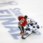 Chicago Blackhawks' Andrew Shaw, left, and Tampa Bay Lightning's Andrej Sustr, of the Czech Republic, chase after a loose puck during the second period in Game 6 of the NHL hockey Stanley Cup Final series on Monday, June 15, 2015, in Chicago. (AP Photo/Charles Rex Arbogast)