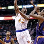 New York Knicks' Lance Thomas (42) shoots over Phoenix Suns' T.J. Warren during the first half of an NBA basketball game, Sunday, March 15, 2015, in Phoenix. (AP Photo/Ralph Freso)
