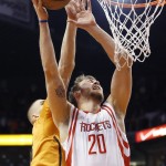 Houston Rockets' Donatas Motiejunas (20), of Lithuania, has his shot blocked by Phoenix Suns' Alex Len, left, of Ukraine, during the first half of an NBA basketball game Friday, Jan. 23, 2015, in Phoenix. (AP Photo/Ross D. Franklin)