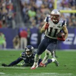 New England Patriots wide receiver Julian Edelman (11) runs past Seattle Seahawks cornerback Tharold Simon (27) during the first half of NFL Super Bowl XLIX football game Sunday, Feb. 1, 2015, in Glendale, Ariz. (AP Photo/Matt Rourke)