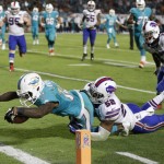 Miami Dolphins wide receiver Jarvis Landry (14) stretches out for a touchdown as he is tackled by Buffalo Bills inside linebacker Preston Brown (52) during the second half of an NFL football game, Thursday, Nov. 13, 2014 in Miami Gardens, Fla. (AP Photo/Alan Diaz)