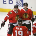 Chicago Blackhawks right wing Marian Hossa celebrates his goal with Jonathan Toews (19) and Brandon Saad, during the second period of an NHL hockey game against the Arizona Coyotes, Monday, Feb. 9, 2015, in Chicago. (AP Photo/Charles Rex Arbogast)