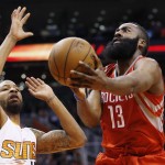 Houston Rockets' James Harden (13) drives past Phoenix Suns' Marcus Morris, left, during the first half of an NBA basketball game Tuesday, Feb. 10, 2015, in Phoenix. (AP Photo/Ross D. Franklin)