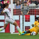 Nigeria goal keeper Precious Dede, right, stops United States' Alex Morgan during the first half of a FIFA Women's World Cup soccer match, Tuesday, June 16, 2015 in Vancouver, New Brunswick, Canada (Darryl Dyck/The Canadian Press via AP)
