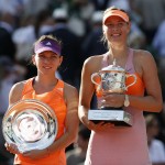 Romania's Simona Halep, left, holds the runner-up trophy, when posing with Russia's Maria Sharapova, right, who won the final of the French Open tennis tournament at Roland Garros stadium, in Paris, France, Saturday, June 7, 2014. Sharapova won in three sets 6-4, 6-7, 6-4. (AP Photo/Darko Vojinovic)