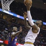 Cleveland Cavaliers' LeBron James, right, drives to the basket against Phoenix Suns' T.J. Warren during the fourth quarter of an NBA basketball game Saturday, March 7, 2015, in Cleveland. (AP Photo/Tony Dejak)