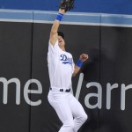 Los Angeles Dodgers center fielder Joc Pederson jumps as he takes a home run away from Arizona Diamondbacks' Yasmany Tomas during the third inning of a baseball game, Wednesday, June 10, 2015, in Los Angeles. (AP Photo/Mark J. Terrill)