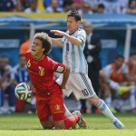 Argentina's Lionel Messi, right, fouls Belgium's Axel Witsel during the World Cup quarterfinal soccer match between Argentina and Belgium at the Estadio Nacional in Brasilia, Brazil, Saturday, July 5, 2014. (AP Photo/Frank Augstein)