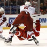 Arizona Coyotes defenseman Connor Murphy (5) checks Detroit Red Wings right wing Luke Glendening during the second period of an NHL hockey game in Detroit on Tuesday, March 24, 2015. (AP Photo/Paul Sancya)