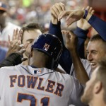  Houston Astros' Dexter Fowler, left, celebrates his run scored against the Arizona Diamondbacks with teammates, including George Springer, top right, during the second inning of a baseball game on Monday, June 9, 2014, in Phoenix. (AP Photo/Ross D. Franklin)