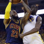 Cleveland Cavaliers forward LeBron James, left, shoots against Golden State Warriors forward Draymond Green during the first half of Game 5 of basketball's NBA Finals in Oakland, Calif., Sunday, June 14, 2015. (AP Photo/Ben Margot)
