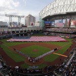 An American Flag is stretched across the outfield during the National Anthem on an opening day baseball game between the Houston Astros and Cleveland Indians, Monday, April 6, 2015, in Houston. (AP Photo/Patric Schneider)