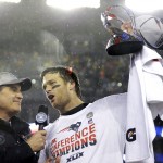 New England Patriots quarterback Tom Brady, right, holds the championship trophy while being interviewed by Jim Nance after the NFL football AFC Championship game Sunday, Jan. 18, 2015, in Foxborough, Mass. The Patriots defeated the Colts 45-7 to advance to the Super Bowl against the Seattle Seahawks. (AP Photo/Matt Slocum)