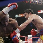 Manny Pacquiao, from the Philippines, right, punches Floyd Mayweather Jr., during their welterweight title fight on Saturday, May 2, 2015 in Las Vegas. (AP Photo/Isaac Brekken)