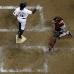  Milwaukee Brewers' Jean Segura celebrates in front of Arizona Diamondbacks catcher Miguel Montero after hitting a two-run home run during the sixth inning of a baseball game Monday, May 5, 2014, in Milwaukee. (AP Photo/Morry Gash)