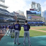 Members of the Colorado Rockies watch the Kentucky Derby on the field at Petco Park prior to a baseball game against the against the San Diego Padre Saturday, May 2, 2015, in San Diego. (AP Photo/Lenny Ignelzi)
