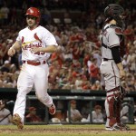 St. Louis Cardinals' Shane Robinson, left, scores on a single by Matt Carpenter as Arizona Diamondbacks catcher Tuffy Gosewisch stands by during the eighth inning of a baseball game Thursday, May 22, 2014, in St. Louis. (AP Photo/Jeff Roberson)
