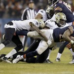 Chicago Bears running back Matt Forte (22) is stopped by New Orleans Saints cornerback Keenan Lewis (28) and defensive end Akiem Hicks (76) during the first half of an NFL football game Monday, Dec. 15, 2014, in Chicago. (AP Photo/Nam Y. Huh)