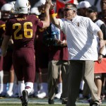 Arizona State punter Matt Haack (26) is congratulated by head coach Todd Graham after kicking the ball to the 1-yard line against Washington State during the first half of an NCAA college football game Saturday, Nov. 22, 2014, in Tempe, Ariz. (AP Photo/Ross D. Franklin)