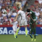 United States' Julie Johnston, left, and Nigeria's Courtney Dike vie for the ball during the first half of a FIFA Women's World Cup soccer game Tuesday, June 16, 2105, in Vancouver, British Columbia, Canada. (Darryl Dyck/The Canadian Press via AP)
