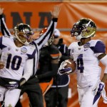 Washington wide receiver Jaydon Mickens (4) scores against Oklahoma State during the second half of the Cactus Bowl NCAA college football game, Friday, Jan. 2, 2015, in Tempe, Ariz. At left is quarterback Cyler Miles. (AP Photo/Matt York)