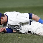 Chicago Cubs right fielder Justin Ruggiano holds his leg in the ninth inning of a baseball game against the Arizona Diamondbacks at Wrigley Field in Chicago on Wednesday, April 23, 2014. (AP Photo/Andrew A. Nelles)