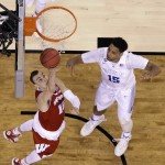 Wisconsin's Sam Dekker drives to the basket in front of Duke's Jahlil Okafor, right, during the first half of the NCAA Final Four college basketball tournament championship game Monday, April 6, 2015, in Indianapolis. (AP Photo/David J. Phillip)