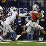Ohio State's Ezekiel Elliott runs past Oregon's Chris Seisay for a touchdown during the first half of the NCAA college football playoff championship game Monday, Jan. 12, 2015, in Arlington, Texas. (AP Photo/David J. Phillip)